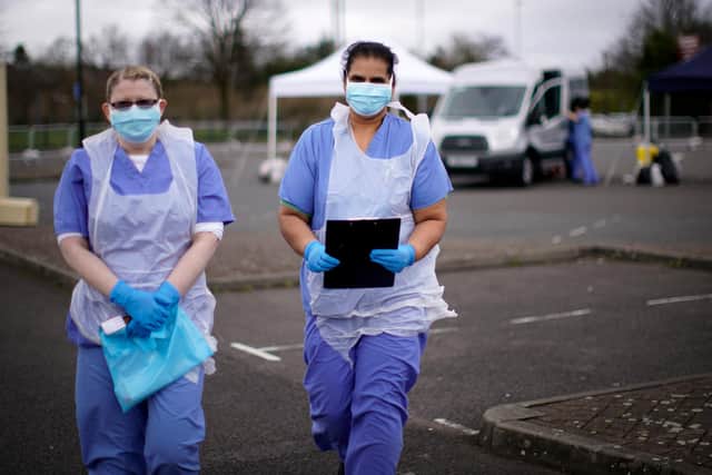 NHS nurses wait for the next patient at a drive through Coronavirus testing site in a car park (Photo by Christopher Furlong/Getty Images)