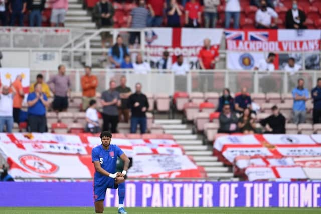 Tyrone Mings of England takes the knee - a gesture against racism - prior to an international friendly vs Romania. (Pic: Getty)
