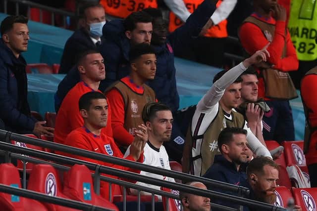 England's midfielder Jack Grealish sits on the bench after being substituted during the UEFA EURO 2020 semi-final football match between England and Denmark.