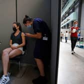 A member of the public receives the Pfizer-BioNTech Covid-19 vaccine in the Turbine Hall at a temporary Covid-19 vaccine centre at the Tate Modern in central London (Photo: TOLGA AKMEN/AFP via Getty Images)