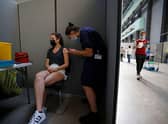 A member of the public receives the Pfizer-BioNTech Covid-19 vaccine in the Turbine Hall at a temporary Covid-19 vaccine centre at the Tate Modern in central London (Photo: TOLGA AKMEN/AFP via Getty Images)