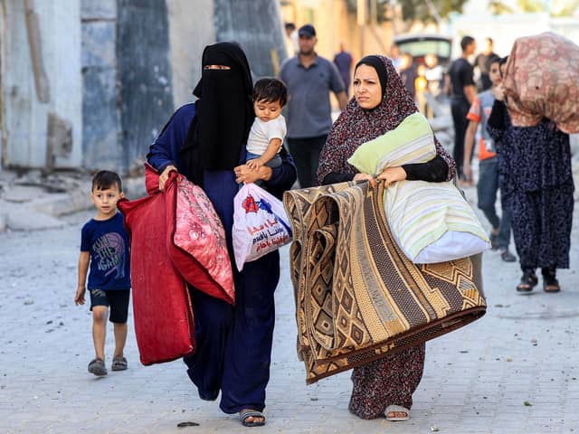 Palestinian women and children flee in the aftermath of an Israeli air strike on Rafah in the southern Gaza Strip sparked by Hamas attacks on Israel last weekend (Picture: Said Khatib/AFP via Getty Images)