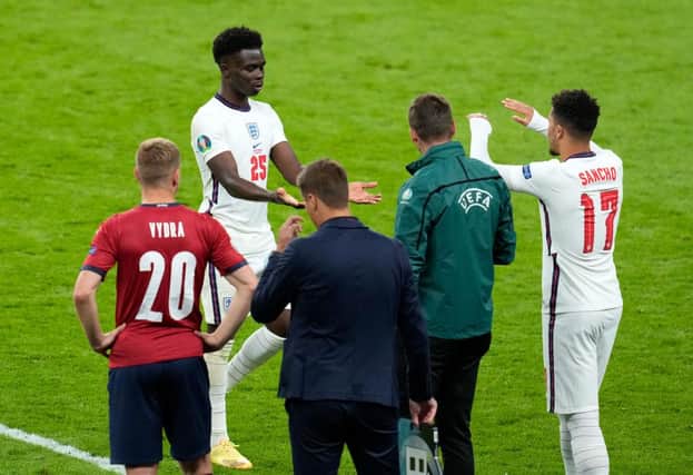 Jadon Sancho of England interacts with team mate Bukayo Saka after he replaced him as substitute against Czech Republic.