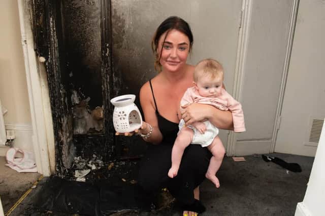 Vikki Henvey with her daughter Tilly in her flat, which has been damaged beyond repair by a fire caused by an exploding wax melt burner (Photo: SWNS)