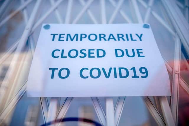 A sign in the window of a shop explaining to customers that it has temporarily closed due to coronavirus in June 2020 (Photo: TOLGA AKMEN/AFP via Getty Images)