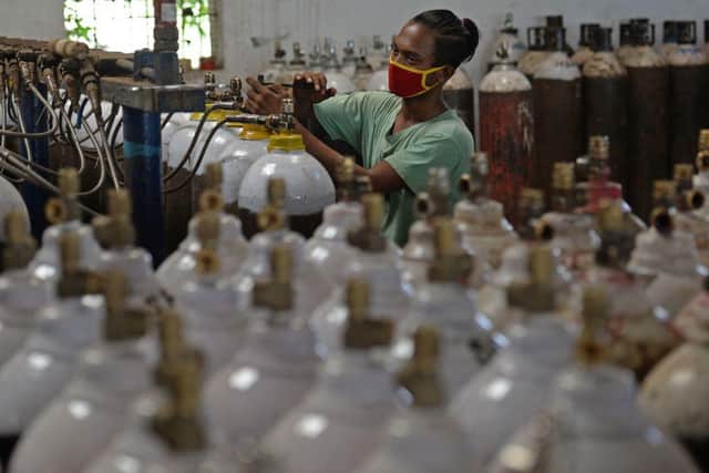 A worker fills medical oxygen cylinders to be transported to hospitals amid Covid-19 coronavirus pandemic at a facility on the outskirts of Chennai.