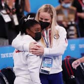 TOKYO, JAPAN - JULY 27: Simone Biles of Team United States is embraced by coach Cecile Landi during the Women's Team Final on day four of the Tokyo 2020 Olympic Games at Ariake Gymnastics Centre on July 27, 2021 in Tokyo, Japan. (Photo by Ezra Shaw/Getty Images)