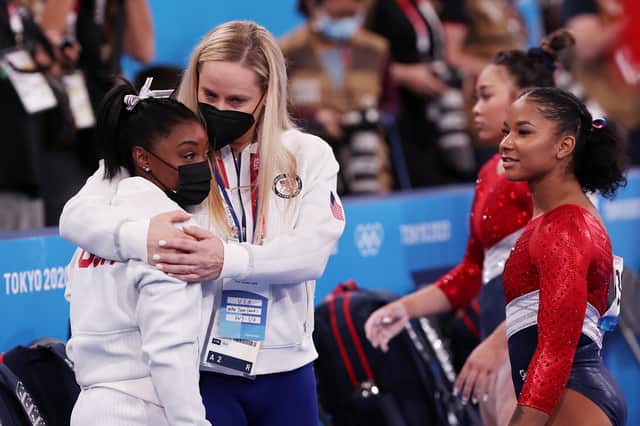 TOKYO, JAPAN - JULY 27: Simone Biles of Team United States is embraced by coach Cecile Landi during the Women's Team Final on day four of the Tokyo 2020 Olympic Games at Ariake Gymnastics Centre on July 27, 2021 in Tokyo, Japan. (Photo by Ezra Shaw/Getty Images)