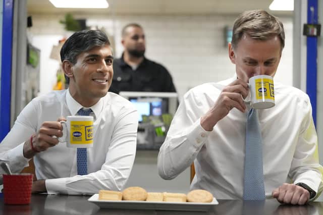 Prime Minister Rishi Sunak and Chancellor of the Exchequer Jeremy Hunt meet staff during a visit to a builders merchant in south east London, after the Chancellor delivered his Budget at the Houses of Parliament.