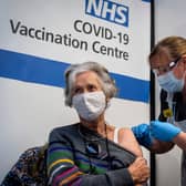 LONDON, ENGLAND - DECEMBER 08: Dr, Doreen Brown, 85, receives the first of two Pfizer/BioNTech Covid-19 vaccine jabs at Guy's Hospital at the start of the largest ever immunisation programme in the UK's history on December 8, 2020 in London, United Kingdom. More than 50 hospitals across England were designated as covid-19 vaccine hubs, the first stage of what will be a lengthy vaccination campaign. NHS staff, over-80s, and care home residents will be among the first to receive the Pfizer/BioNTech vaccine, which recently received emergency approval from the country's health authorities. (Photo by Victoria Jones - Pool / Getty Images)