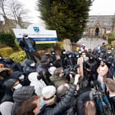 Protesters give a statement to members of the media outside Batley Grammar School in West Yorkshire (PA Media)