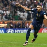 France's Kylian Mbappe celebrates scoring his side's third goal of the game and a hat-trick from the penalty spot in extra time during the FIFA World Cup final at Lusail Stadium, Qatar.