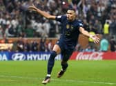 France's Kylian Mbappe celebrates scoring his side's third goal of the game and a hat-trick from the penalty spot in extra time during the FIFA World Cup final at Lusail Stadium, Qatar.
