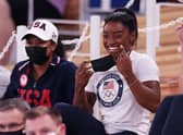 Simone Biles of Team United States smiles during the Women's Uneven Bars Final.