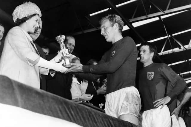 Queen Elizabeth presents the Jules Rimet Cup to captain Bobby Moore in 1966, after England beat West Germany 4-2 in extra time in the World Cup final (AFP via Getty)
