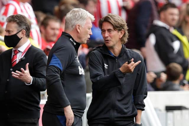 Brentford manager Thomas Frank (R) and West Ham United manager David Moyes talk before the pre season friendly match between Brentford and West Ham United at Brentford Community Stadium.