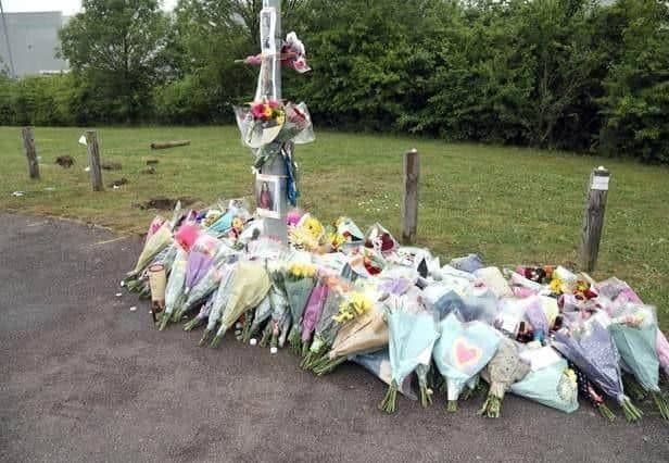 Floral tributes to the victims were left at the scene
