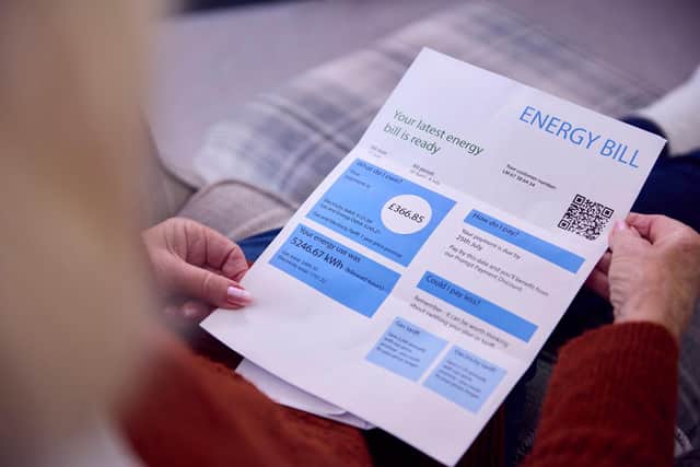 Woman looking at energy bill invoice.