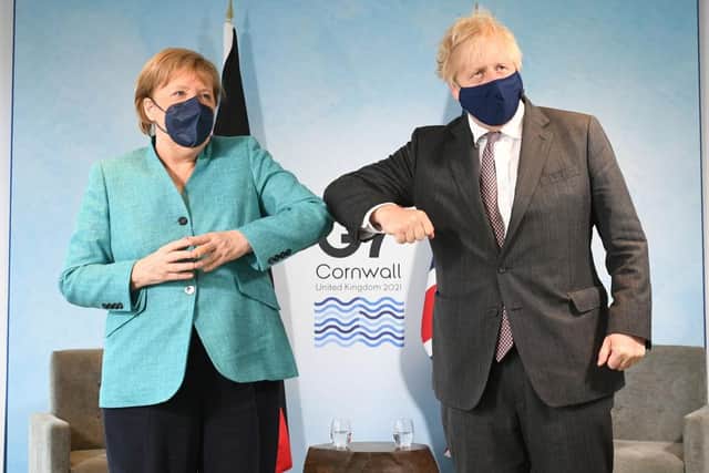 Boris Johnson greeting German Chancellor Angela Merkel, ahead of a bilateral meeting during the G7 summit in Carbis Bay (Photo by Stefan Rousseau - WPA Pool/Getty Images)