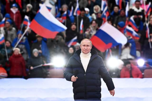 Vladimir Putin addressed a crowd of flag-waving supporters at the Luzhniki stadium in Moscow (Picture: Sergei Guneyev/pool/AFP via Getty Images)