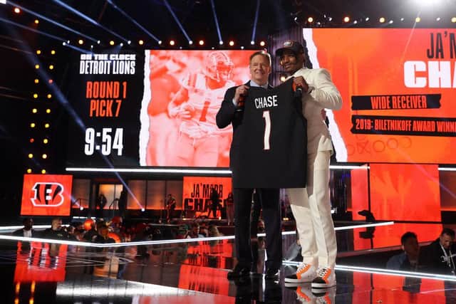 Ja'Marr Chase poses with NFL Commissioner Roger Goodell onstage after being selected fifth by the Cincinnati Bengals during round one of the 2021 NFL Draft.