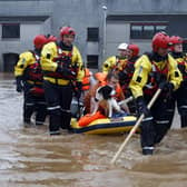 Members of the coastguard rescue team wade through the flood waters to evacuate a man and a dog in Brechin. The Met Office have issued three days of weather warnings. Picture: Jeff J Mitchell/Getty Images