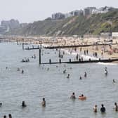 Sunbathers enjoy sunny weather on Boscombe beach in Bournemouth, where swimmers were recently evacuated from the water after a 'large marine animal' was spotted (Photo: Adrian DENNIS / AFP) (Photo by ADRIAN DENNIS/AFP via Getty Images)
