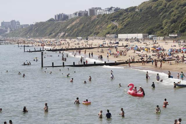 Sunbathers enjoy sunny weather on Boscombe beach in Bournemouth, where swimmers were recently evacuated from the water after a 'large marine animal' was spotted (Photo: Adrian DENNIS / AFP) (Photo by ADRIAN DENNIS/AFP via Getty Images)
