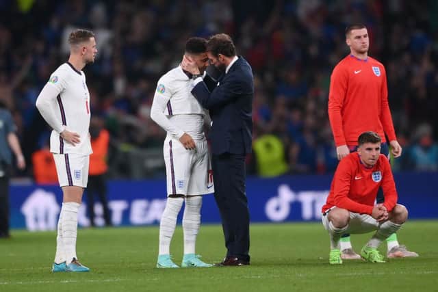 Gareth Southgate, Head Coach of England consoles Jadon Sancho. (Photo by Laurence Griffiths/Getty Images)