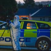Officers in white coats could be seen at the scene as the road remained closed and nearby residents were not allowed back into their homes (Picture: Getty Images)