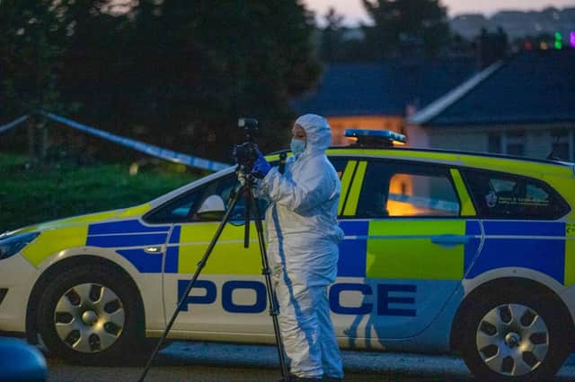 Officers in white coats could be seen at the scene as the road remained closed and nearby residents were not allowed back into their homes (Picture: Getty Images)
