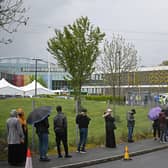 Members of the public queue to receive a Covid-19 vaccine at a temporary vaccination centre at the Essa academy in Bolton (Photo by Oli SCARFF / AFP)