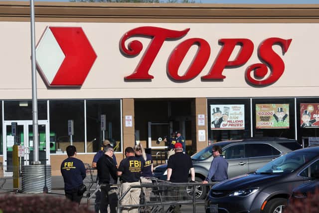 BUFFALO, NEW YORK - MAY 15: Police and FBI agents continue their investigation of the shooting at Tops market on May 15, 2022 in Buffalo, New York. A gunman opened fire at the store yesterday killing ten people and wounding another three. The attack was believed to be motivated by racial hatred.  (Photo by Scott Olson/Getty Images)