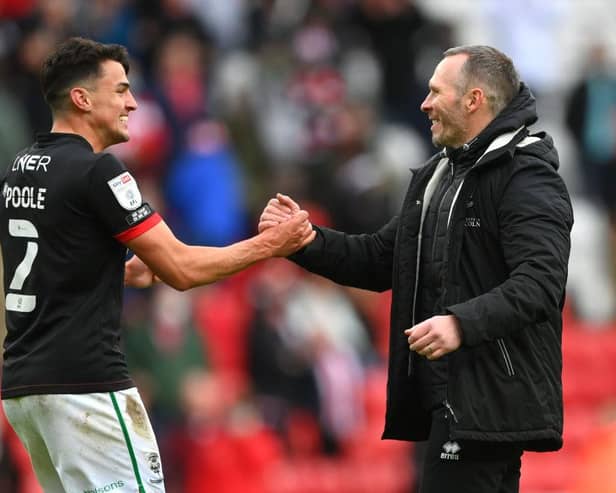 Lincoln City manager Michael Appleton congratulates Regan Poole after reaching the final of the League One play-offs.