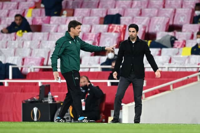 Fourth official Matej Jug (L) interacts with Mikel Arteta during the semi-final second leg match between Arsenal and Villareal.