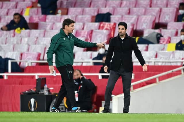 Fourth official Matej Jug (L) interacts with Mikel Arteta during the semi-final second leg match between Arsenal and Villareal.