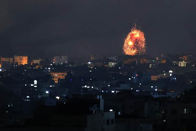 An explosion lights the sky following an Israeli air strike on Beit Lahia in the northern Gaza Strip on May 14, 2021 (Photo by MOHAMMED ABED/AFP via Getty Images)