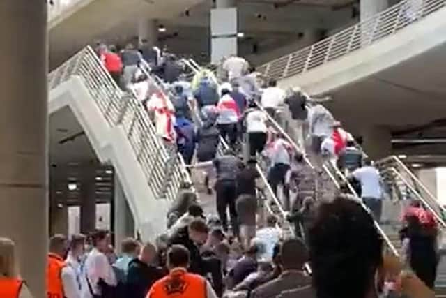Screengrab taken with permission from video posted on twitter by @MichelleOwen7 of people running up steps as they try to force their way in Wembley Stadium, London, ahead of the UEFA Euro 2020 Final between England and Italy on Sunday. Issue date: Monday July 12, 2021. (PA images)