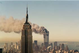 The twin towers of the World Trade Centre in New York burn behind the Empire State Building on September 11, 2001  (AP Photo/Marty Lederhandler/FILE)