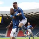 Shaun Rooney of St Johnstone celebrates after scoring with Isaac Olaofe  during the Scottish Cup Final between Hibernian and St Johnstone at Hampden Park.