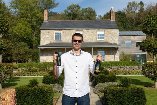 Simon Williams in front of his new £2m Devon house which he won in an Omaze competition