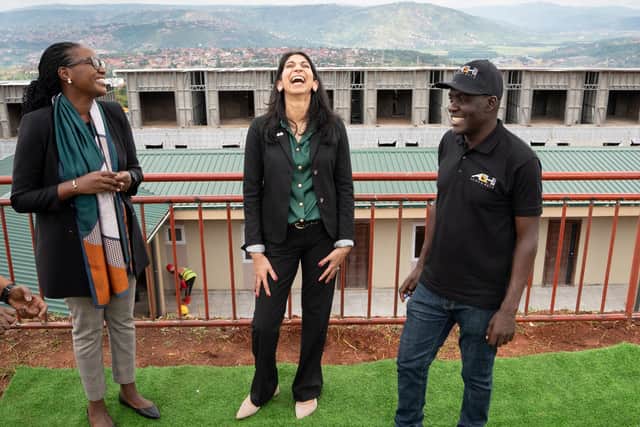 Home Secretary Suella Braverman laughs as she tours a building site on the outskirts of Kigali, Rwanda, where deported migrants are planned to be housed. (Credit: Stefan Rousseau/PA)