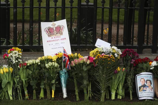 Bunches of flowers were left outside Windsor Castle following the death of the Duke of Edinburgh at the age of 99. (PA).