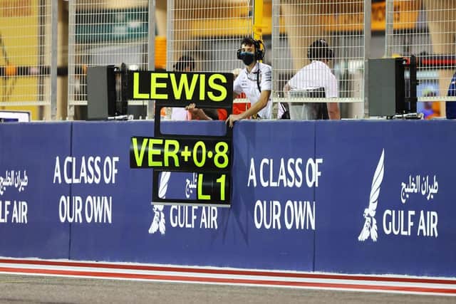 A Mercedes AMG Petronas F1 Team member holds a timing board from the pitwall to show the gap between Lewis Hamilton and Max Verstappen during the F1 Grand Prix of Bahrain at Bahrain International Circuit on March 28, 2021 in Bahrain, Bahrain.