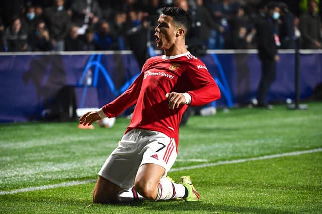 Cristiano Ronaldo celebrates after scoring his second goal during the UEFA Champions League group F football match between Atalanta and Manchester United at the Azzurri d'Italia stadium. (Photo by MARCO BERTORELLO/AFP via Getty Images)