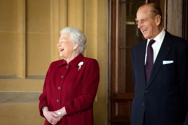 Queen Elizabeth II and Prince Philip share a joke as they bid farewell to Irish President Michael D. Higgins at Windsor Castle on April 11, 2014 (Getty Images)