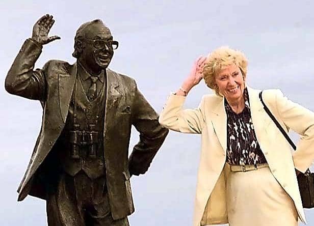Joan Morecambe, the widow of comedian Eric Morecambe, poses next to his statue.
