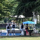 French forensic police officers work at the scene of a stabbing attack in the 'Jardins de l'Europe' park in Annecy, in the French Alps