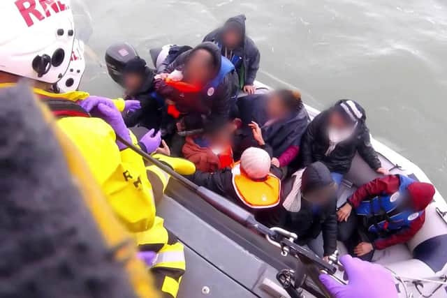 The Royal National Lifeboat Institution (RNLI) has released a video of a dinghy full of 12 migrants, including a baby and child, being rescued by the RNLI in the English Channel in 2019 (PA)