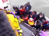 The Royal National Lifeboat Institution (RNLI) has released a video of a dinghy full of 12 migrants, including a baby and child, being rescued by the RNLI in the English Channel in 2019 (PA)